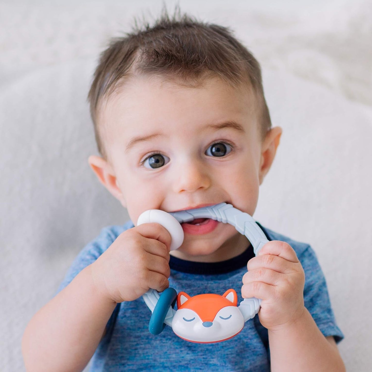 Itzy Ritzy Silicone Teether with Rattle; Rattle Teether Features Rattling Sound, Two Silicone Teething Rings and Raised Texture to Soothe Gums; Ages 3 Months and Up (Fox)