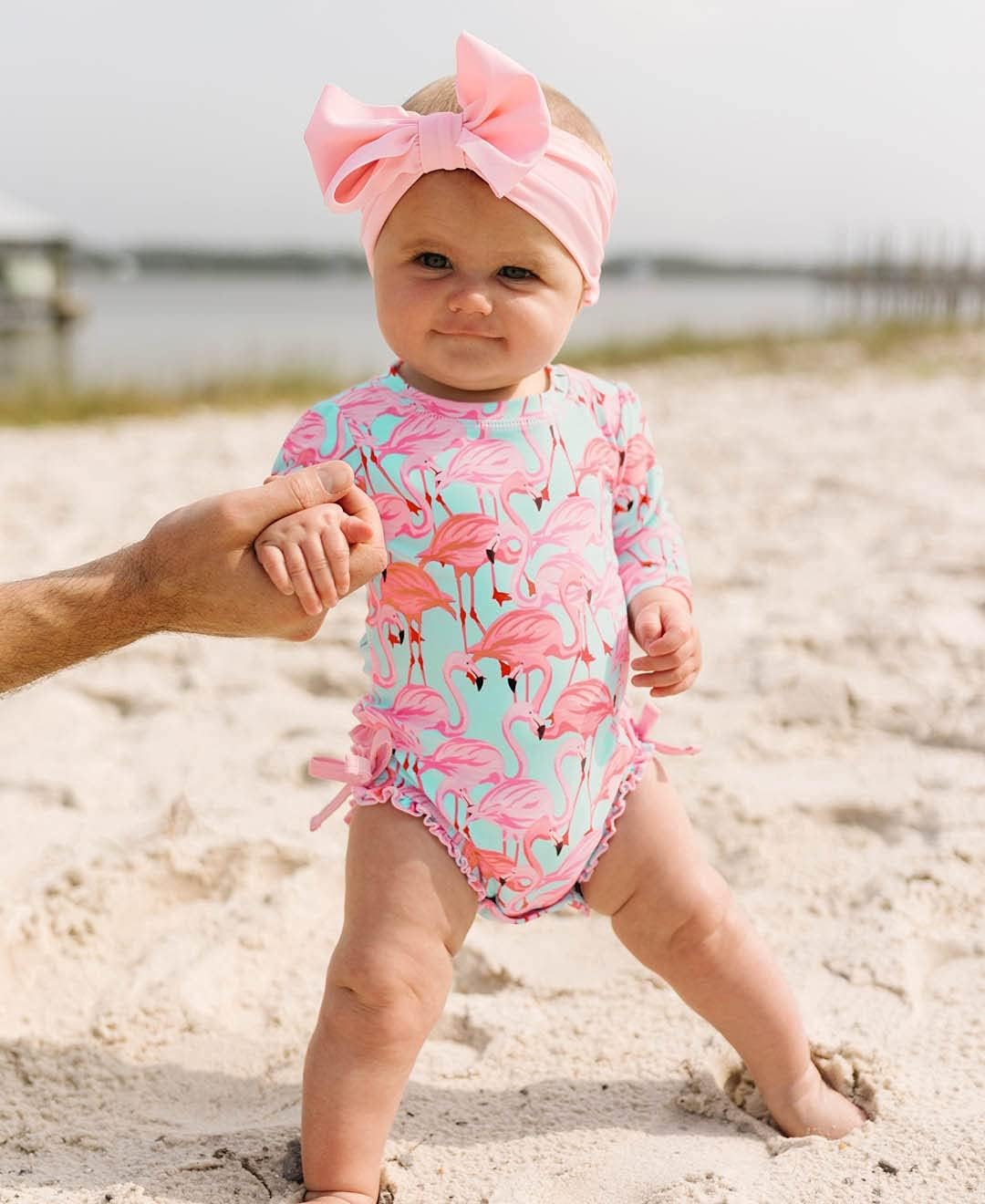 RuffleButts Baby Girls UPF 50+ Sun Protection Novelty Print Long Sleeve One Piece Rash Guard Swimsuit with Zipper