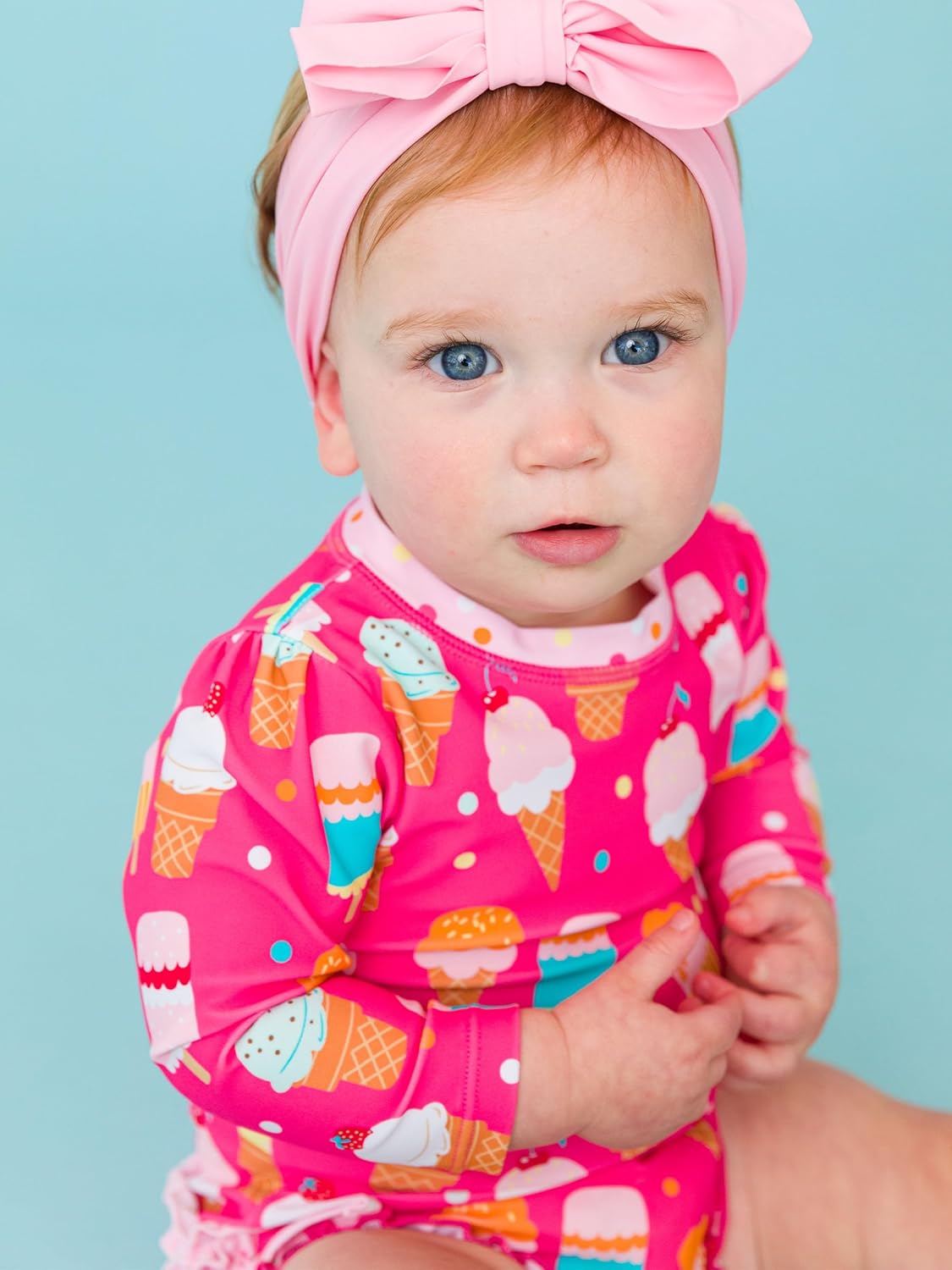 RuffleButts Baby Girls UPF 50+ Sun Protection Novelty Print Long Sleeve One Piece Rash Guard Swimsuit with Zipper