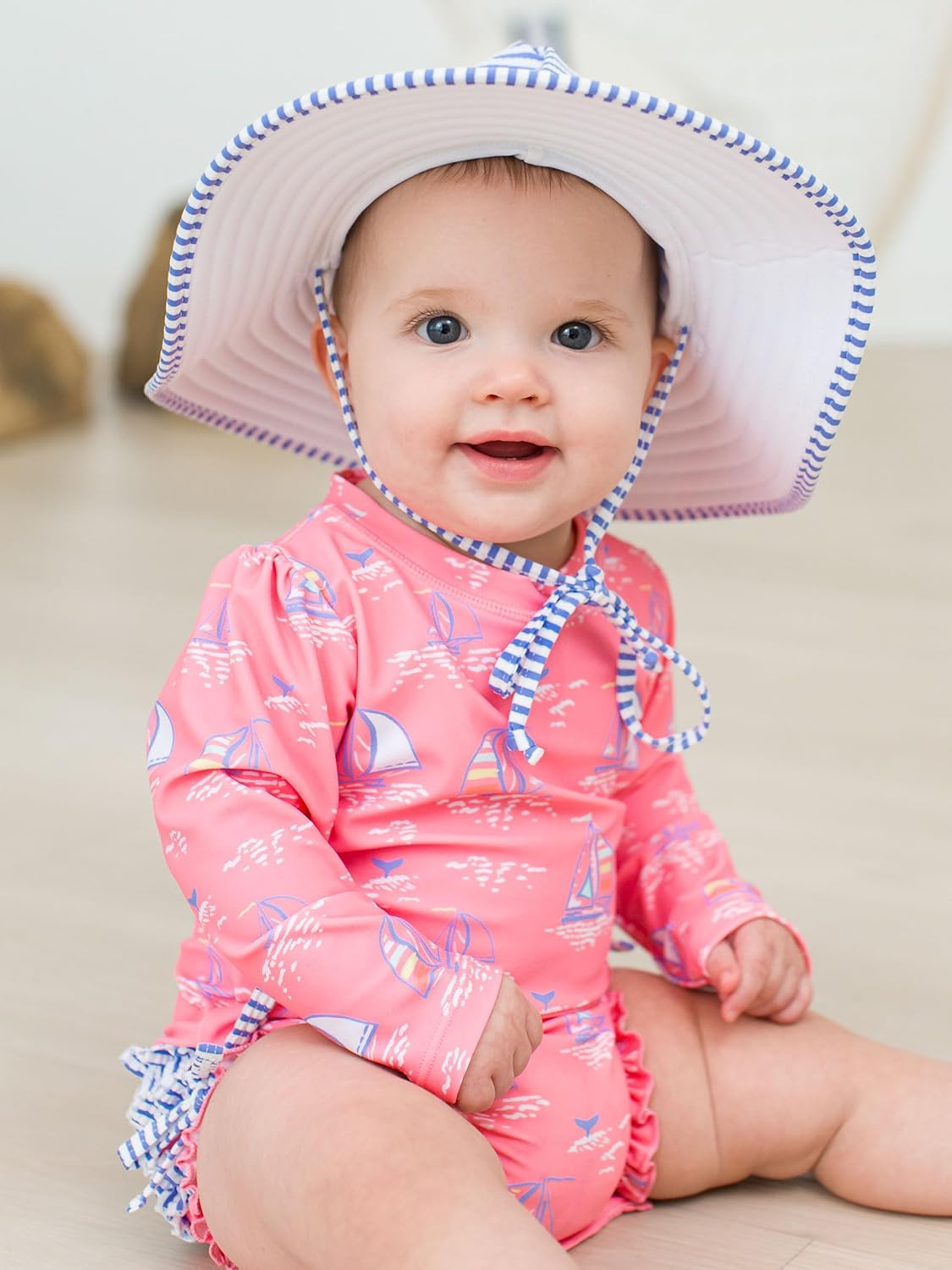RuffleButts Baby Girls UPF 50+ Sun Protection Novelty Print Long Sleeve One Piece Rash Guard Swimsuit with Zipper