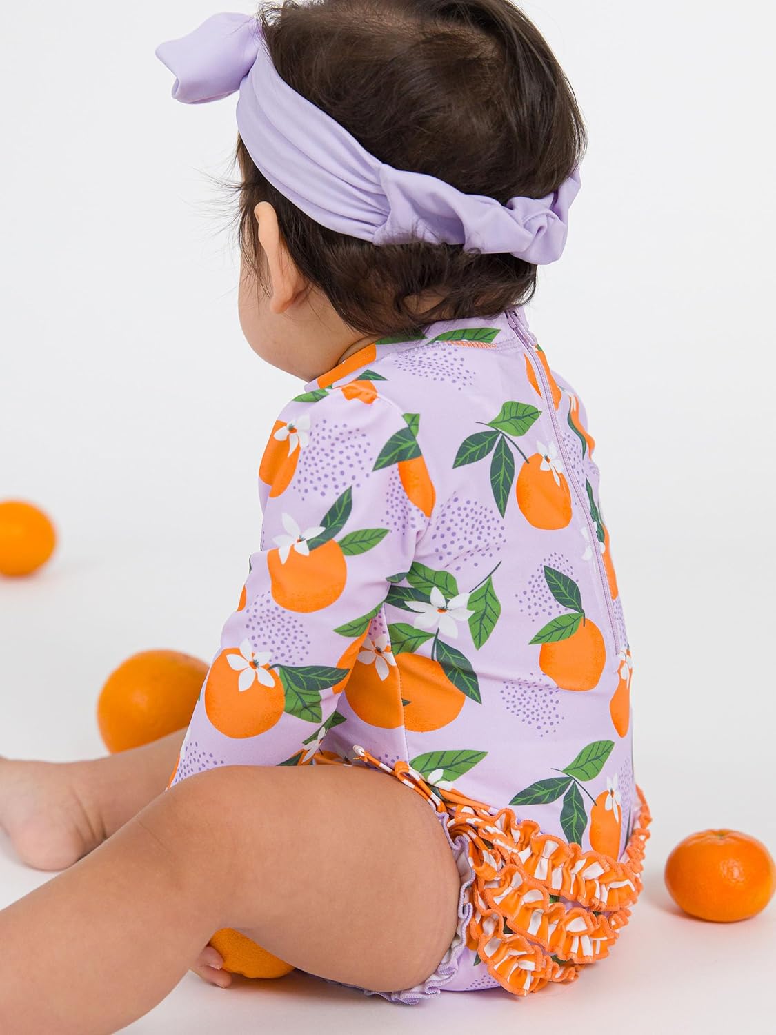 RuffleButts Baby Girls UPF 50+ Sun Protection Novelty Print Long Sleeve One Piece Rash Guard Swimsuit with Zipper