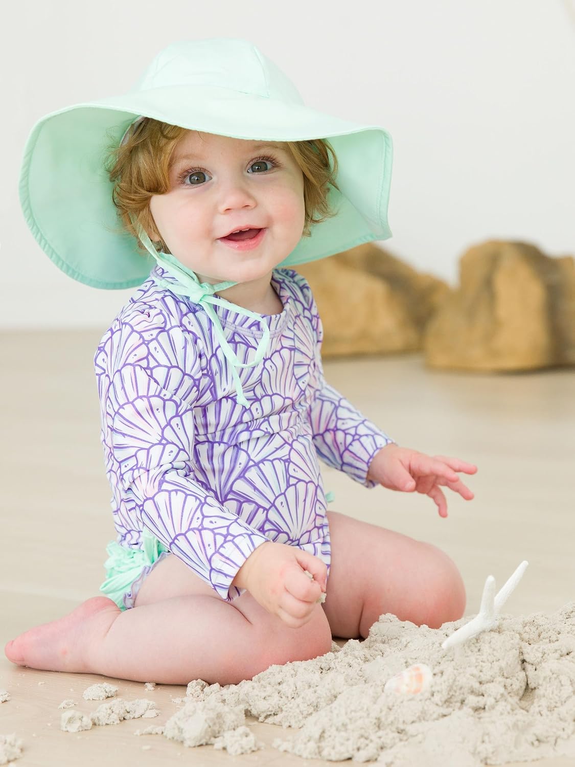 RuffleButts Baby Girls UPF 50+ Sun Protection Novelty Print Long Sleeve One Piece Rash Guard Swimsuit with Zipper