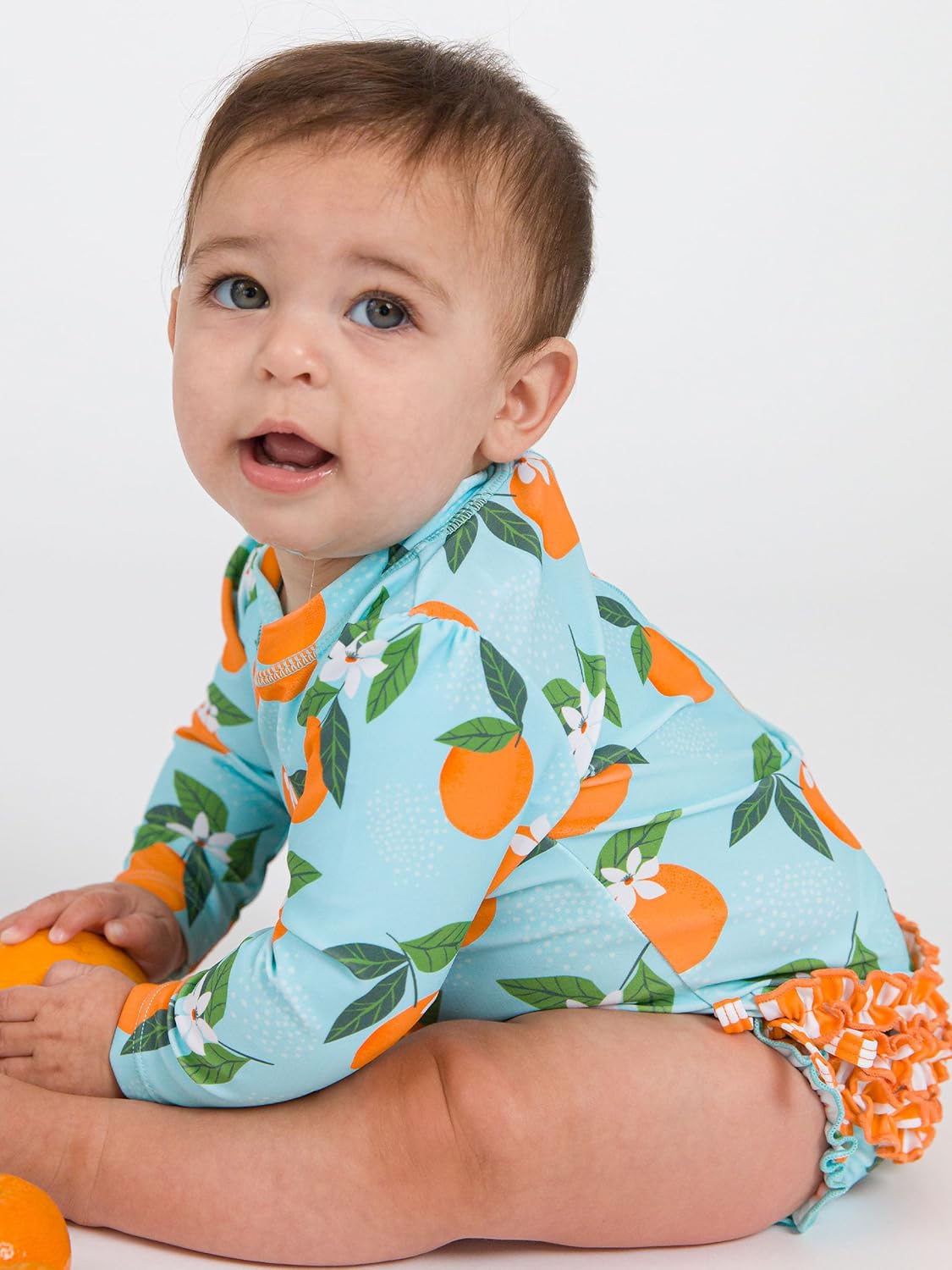 RuffleButts Baby Girls UPF 50+ Sun Protection Novelty Print Long Sleeve One Piece Rash Guard Swimsuit with Zipper