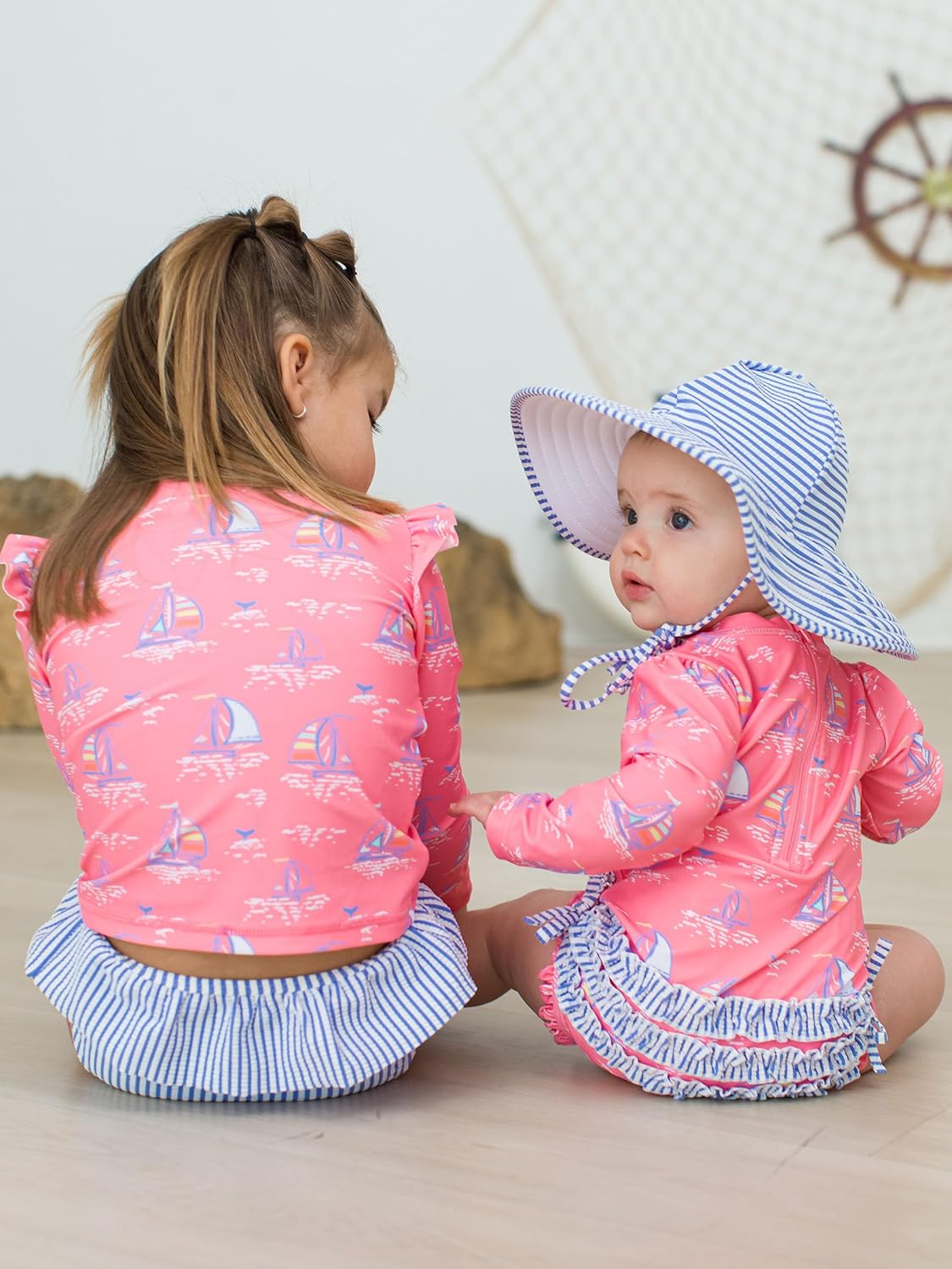 RuffleButts Baby Girls UPF 50+ Sun Protection Novelty Print Long Sleeve One Piece Rash Guard Swimsuit with Zipper