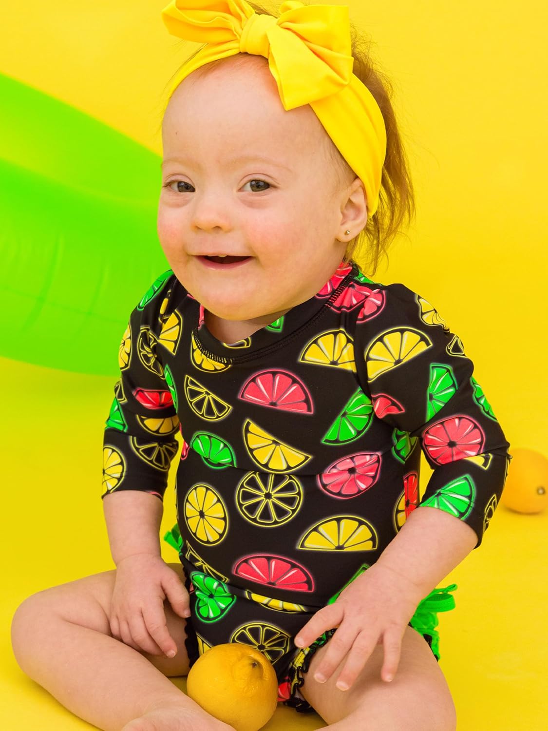 RuffleButts Baby Girls UPF 50+ Sun Protection Novelty Print Long Sleeve One Piece Rash Guard Swimsuit with Zipper