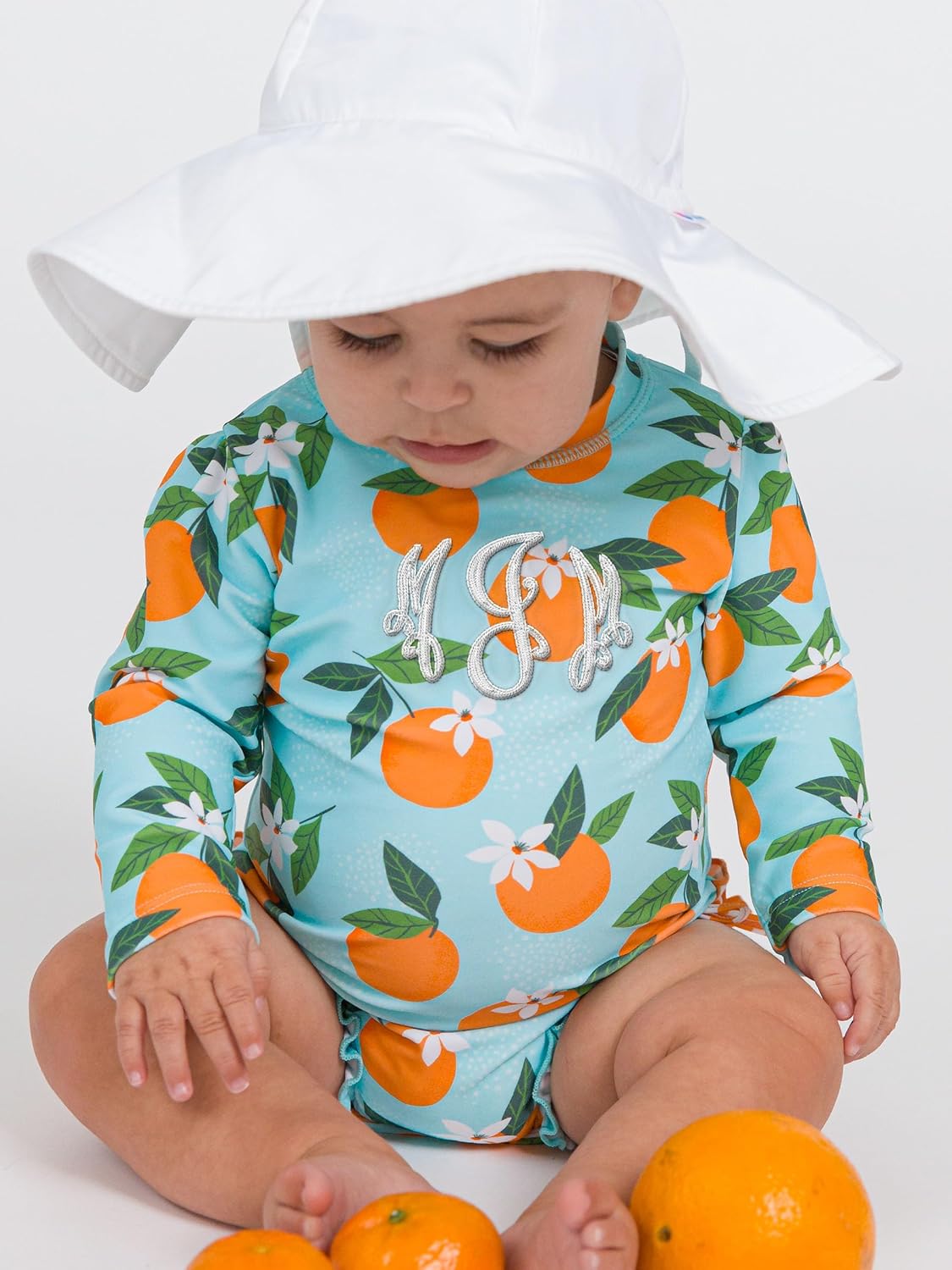 RuffleButts Baby Girls UPF 50+ Sun Protection Novelty Print Long Sleeve One Piece Rash Guard Swimsuit with Zipper