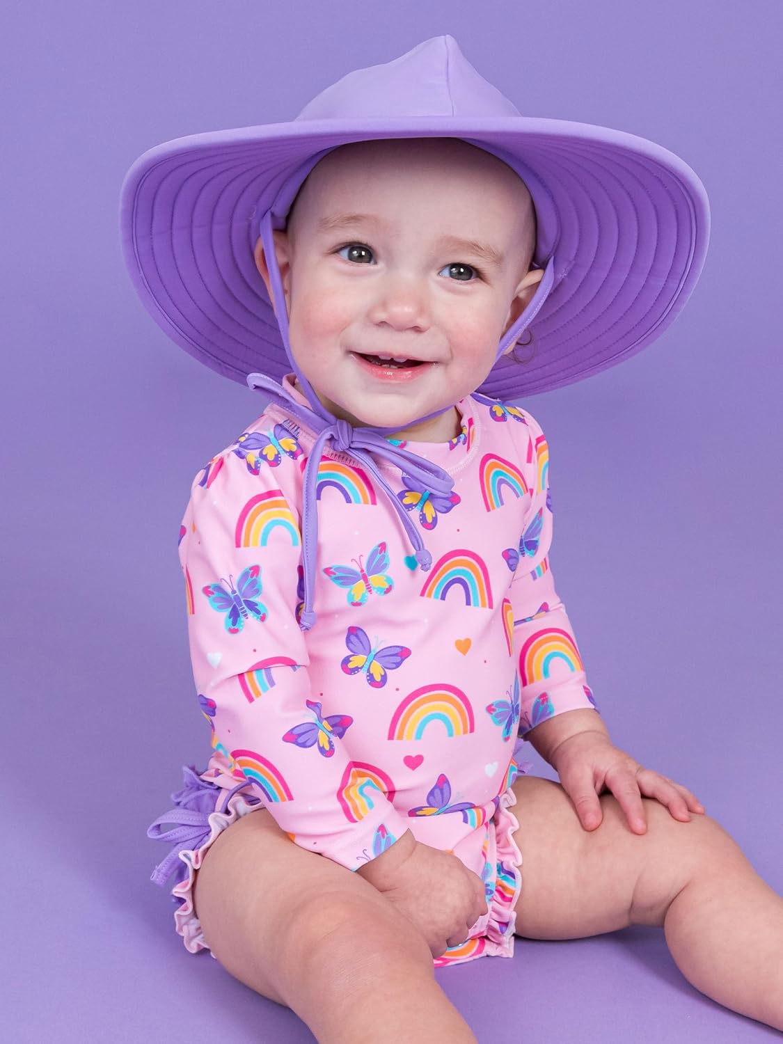 RuffleButts Baby Girls UPF 50+ Sun Protection Novelty Print Long Sleeve One Piece Rash Guard Swimsuit with Zipper