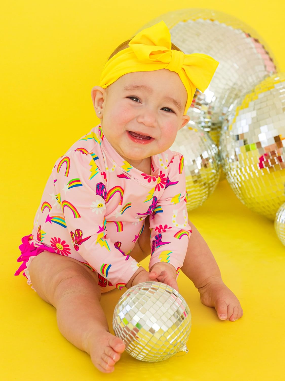 RuffleButts Baby Girls UPF 50+ Sun Protection Novelty Print Long Sleeve One Piece Rash Guard Swimsuit with Zipper