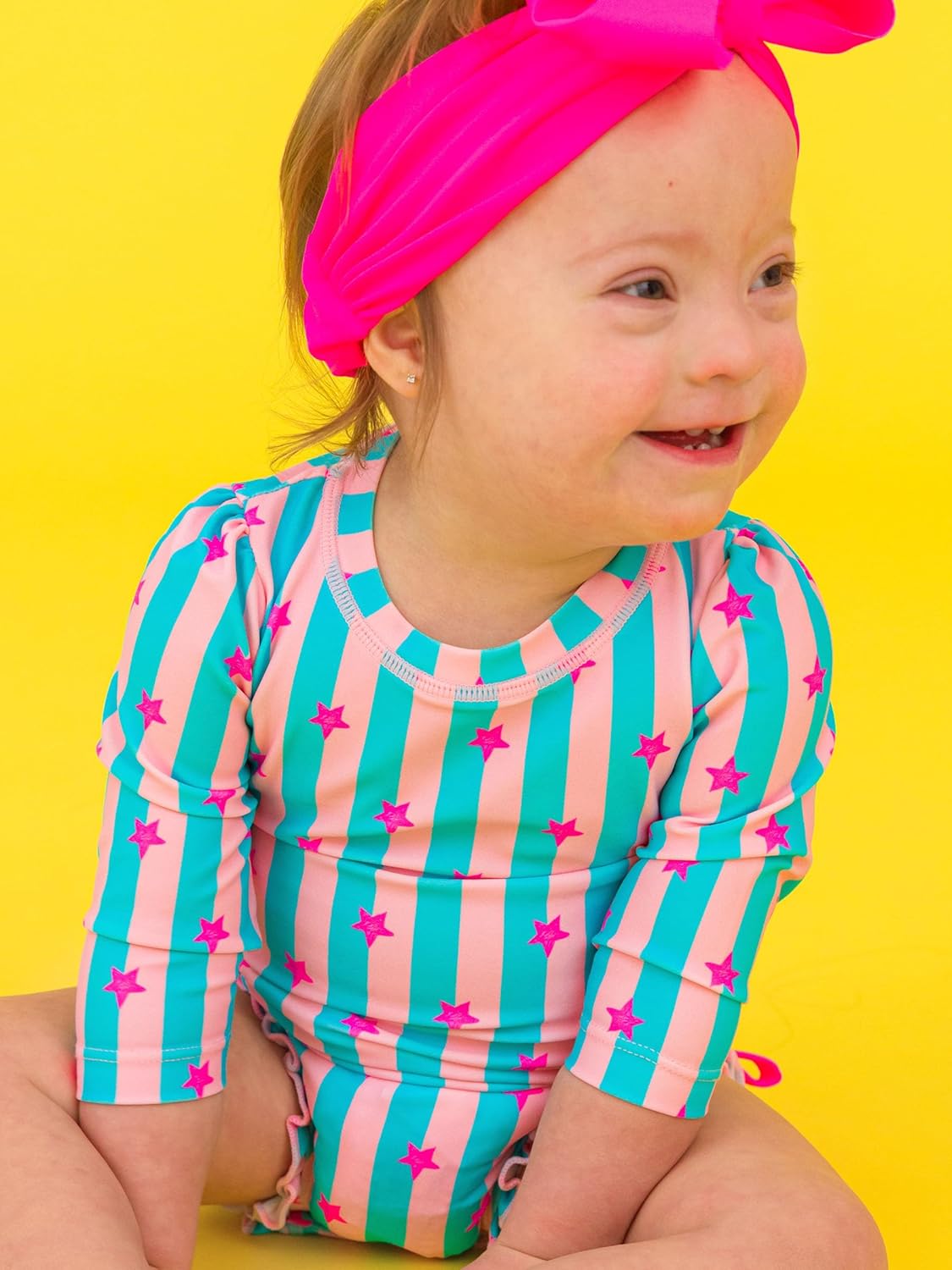RuffleButts Baby Girls UPF 50+ Sun Protection Novelty Print Long Sleeve One Piece Rash Guard Swimsuit with Zipper