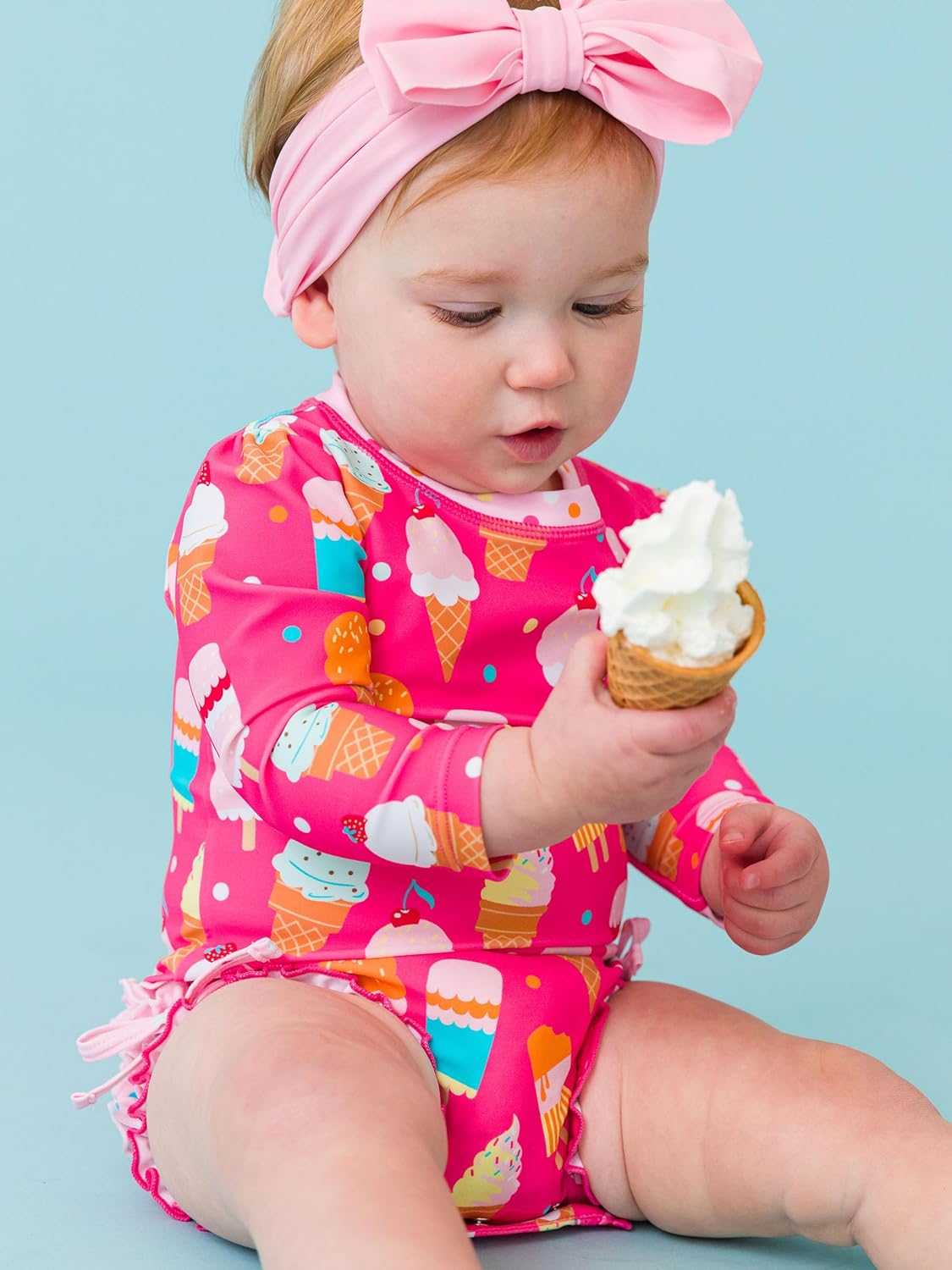 RuffleButts Baby Girls UPF 50+ Sun Protection Novelty Print Long Sleeve One Piece Rash Guard Swimsuit with Zipper
