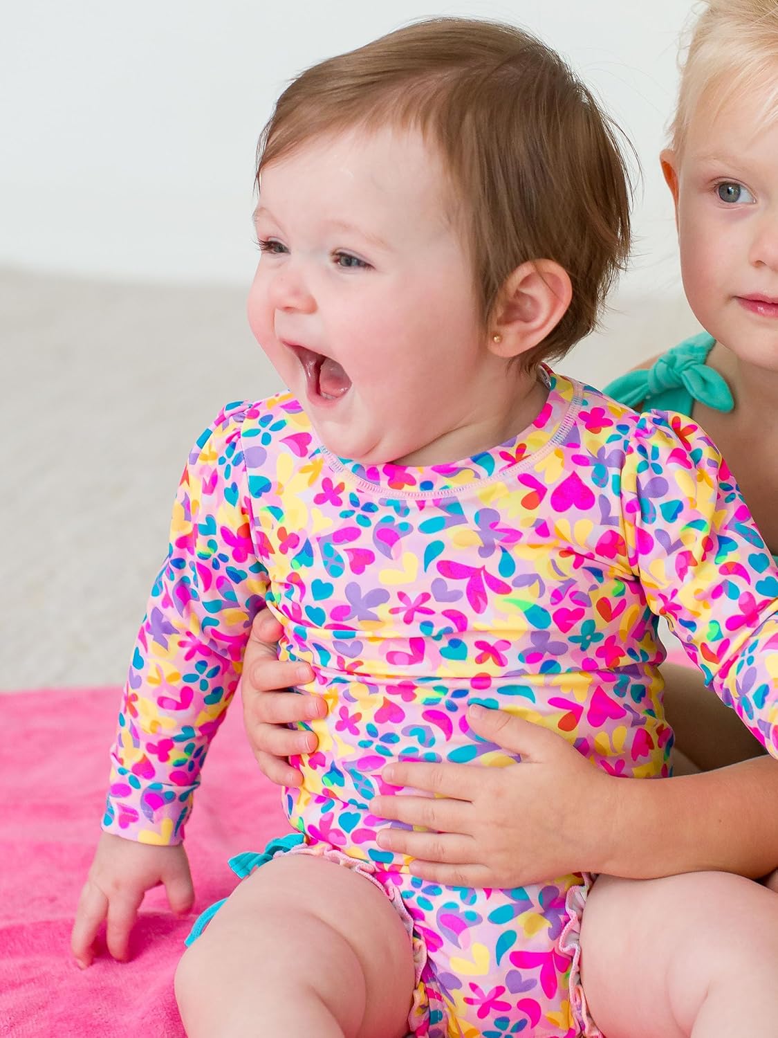 RuffleButts Baby Girls UPF 50+ Sun Protection Novelty Print Long Sleeve One Piece Rash Guard Swimsuit with Zipper
