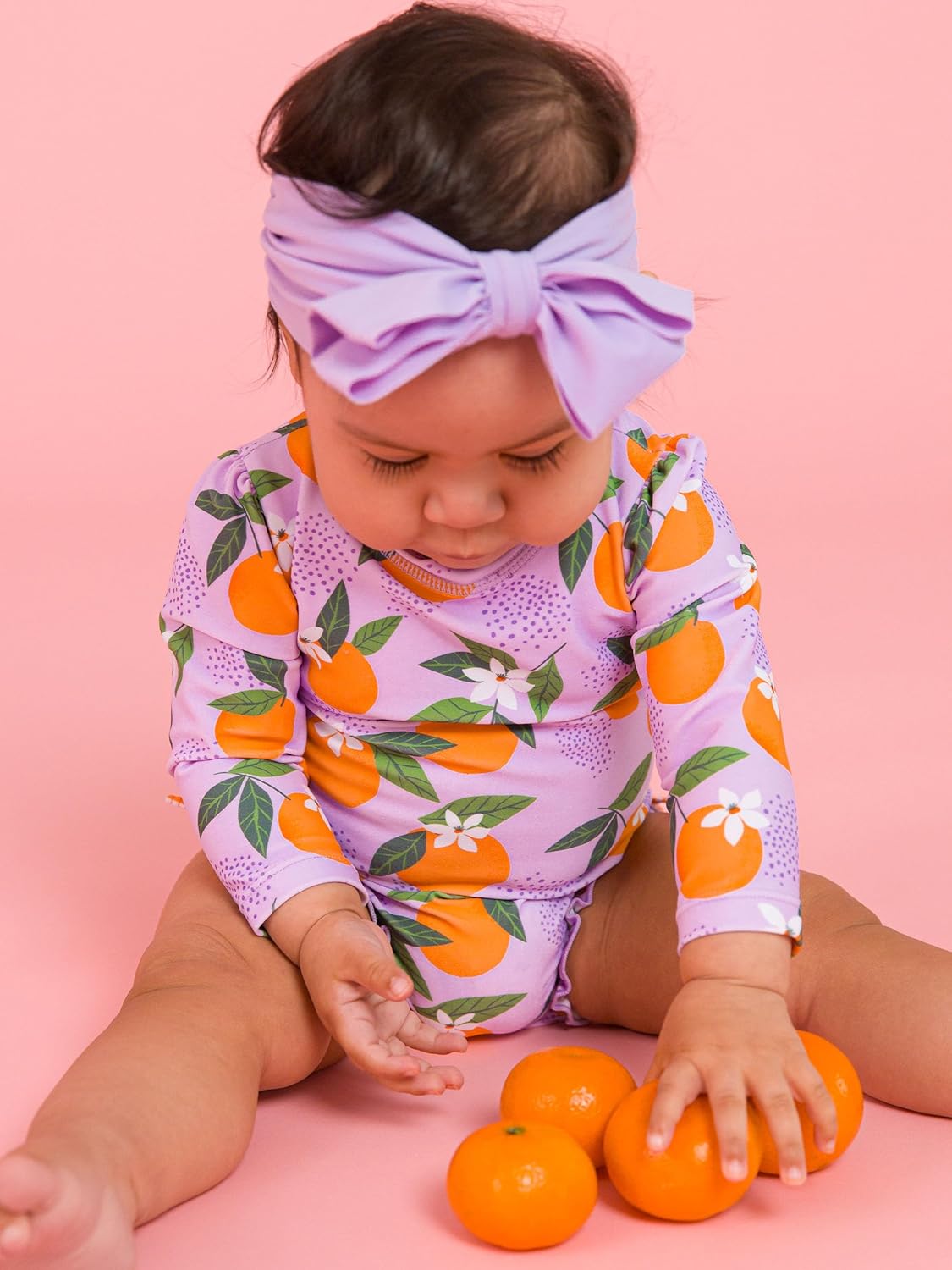 RuffleButts Baby Girls UPF 50+ Sun Protection Novelty Print Long Sleeve One Piece Rash Guard Swimsuit with Zipper