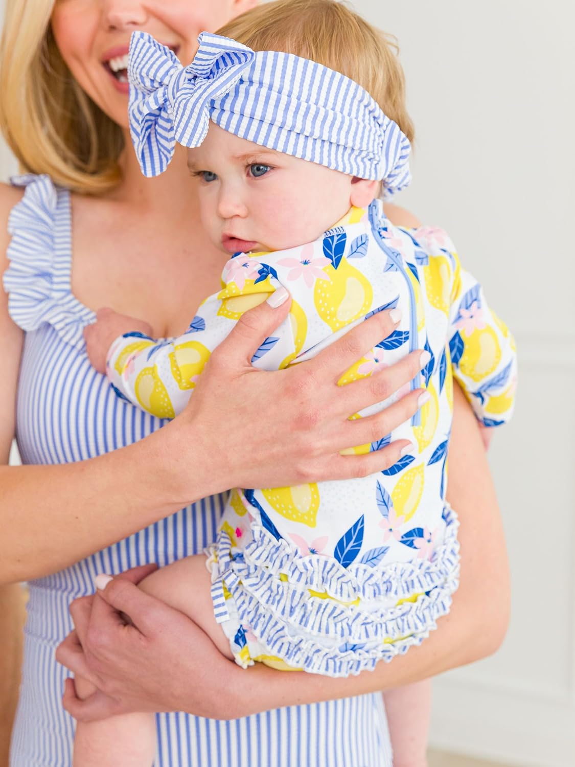 RuffleButts Baby Girls UPF 50+ Sun Protection Novelty Print Long Sleeve One Piece Rash Guard Swimsuit with Zipper