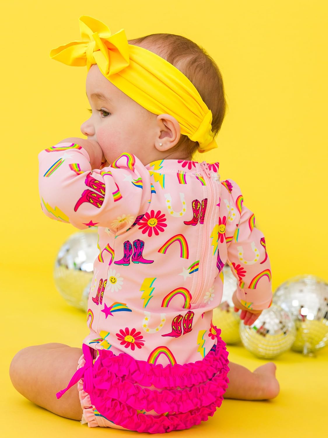 RuffleButts Baby Girls UPF 50+ Sun Protection Novelty Print Long Sleeve One Piece Rash Guard Swimsuit with Zipper