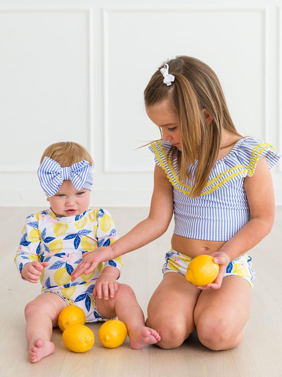 RuffleButts Baby Girls UPF 50+ Sun Protection Novelty Print Long Sleeve One Piece Rash Guard Swimsuit with Zipper